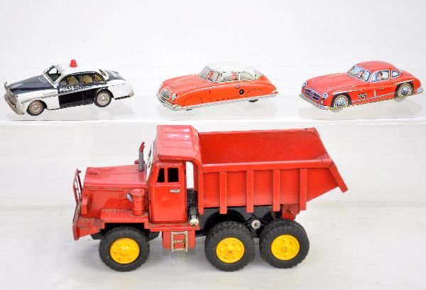 4 Vintage Tin Vehicles: SSS 11" Euclid dump truck with spring dump action; Japanese Amazon 6" Volvo "Polis" Car; W. German Tippco 6" coupe, wind-up mechanism functions, no key, with steerable wheels; Unmarked 6" Mercedes Gul