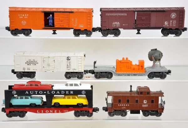 6 Lionel Freight Cars: Includes 3472 milk car, car only; 3484 PRR operating boxcar; 3620 searchlight car; 3484-25 GN operating boxcar; 6414 auto-loader, some chrome wear; 6457 caboose. All show light to moderate playwear, C