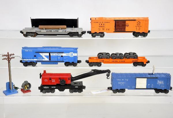 6 Lionel Freight Cars: 6352 ice car, 4 data lines; 6362-55 truck car, 1 load run; 3361 log dump with load & bin; 3530 generator car, long stripe & blue base pole, no lens; 6560 crane. All show light to moderate playwear, C7