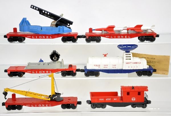 6 Late Lionel Freight Cars: 3470 aerial target car with clear stack, packet with dry balloons & instructions; 6650 launcher, no missile; 6823 missile car, no bands; 6822 searchlight; 6130 work caboose; 6670 flat with derrick. Al