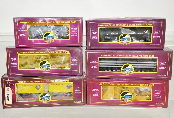 6 MTH Freight Cars: Includes 20-96003 tank car; 98108 piggy-back flat; 94502 stock car; 90007a pipe flat; 98226 spreader; 90006d tank car. All appear unrun with boxes, C9. Some boxes in this lot may have light to moderat