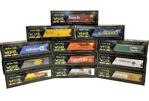 12 Weaver Freight Cars: All 3-rail hi rail cars. All different and appear unrun with boxes. Boxes have some graffiti and boxes are musty, cars are C9
