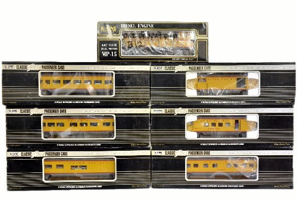 7Pc K-Line UP Passenger Set: Includes K2236 MP-15 diesel; 15" aluminum passenger cars include K4690-16327 baggage; 15902 RPO; 31305 Pullman; 3700 coach; 38003 diner & 31575 observation. All appear unrun with some graffiti on boxe