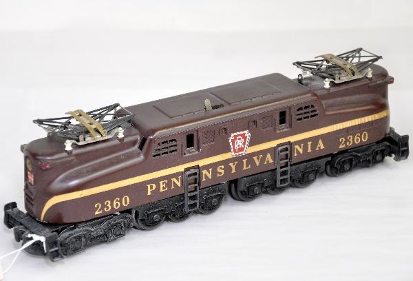 Lionel 2360 PRR GG1 Electric: Late 1950s version with single stripe & even vents. Decals are 100% and lettering is even with clean battery compartment. It shows light playwear, though dusty, C7-7+