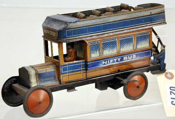 Unusual Nifty Omnibus Toy: 9 1/2" long, litho tin with driver inside & ticket taker on rear platform with top seats. Mechanism is not functional (spring broken, but appears complete with bell). It is fairly clean, showing light