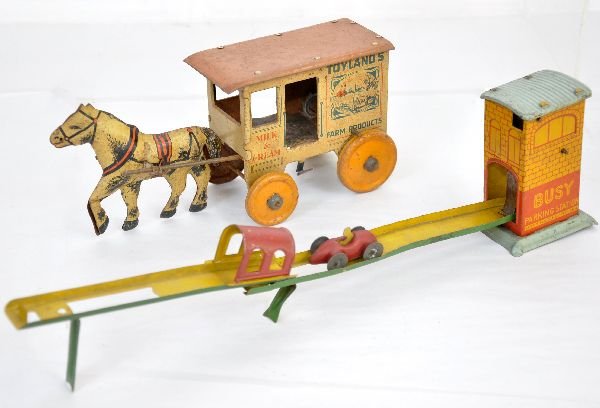 2 Early Marx Tin Toys: Busy Parking Station, mechanism functional with original car, ramp missing tab; Toyland Dairy cart, mechanism missing spring. Both are clean, but litho is somewhat faded, C6