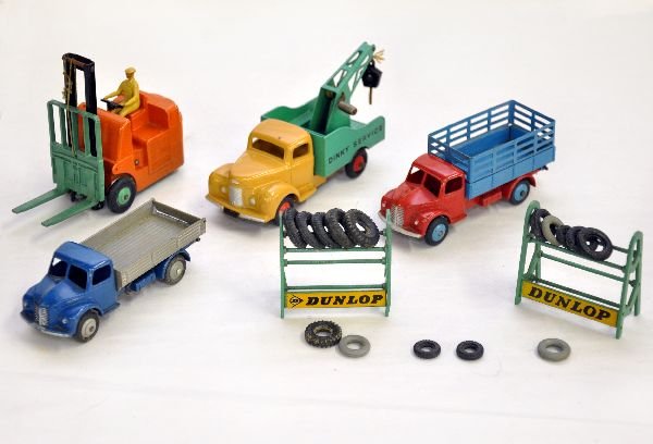 6 Pc Dinky Toy Lot: Includes a 343 Dodge farm truck; 414 Dodge tipper; 401 Climax forklift with blue hubs; 430 Commer wrecker & 2 #786 Dunlop Tire racks with several original tires. All are fairly clean & shiny and show 