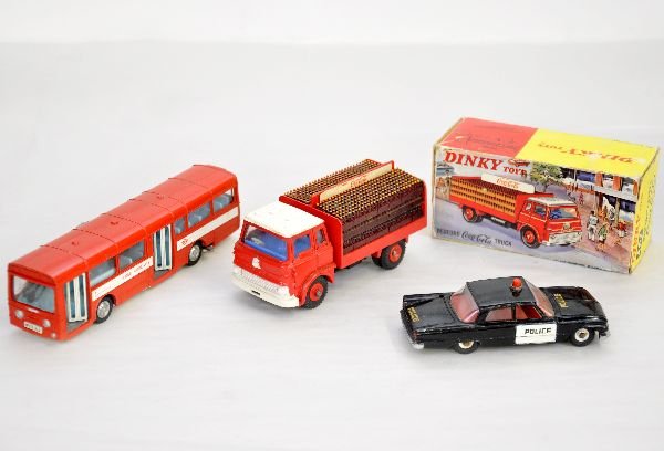 3 Dinky Commercial Vehicles: Includes 283 AEC Merlin Red Arrow Bus with opening doors & bell; 258 Ford Fairlane Police car, missing antenna; 402 Bedford Coca-Cola Truck with all 6 racks, boxed. They show light to moderate playwea