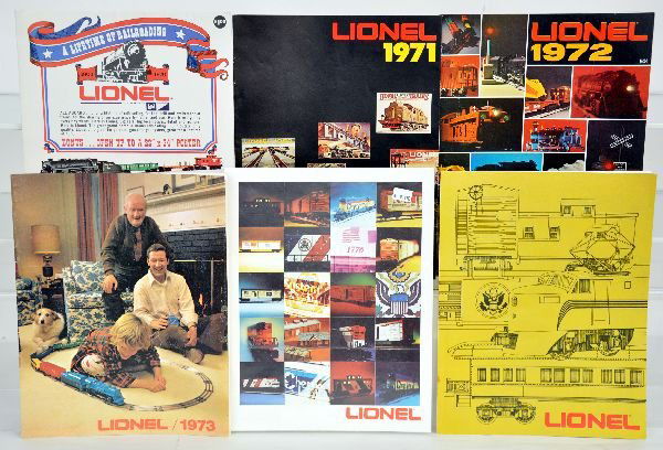 Lionel Catalogs & Antique Toy Worlds: Selection of Lionel catalogs from 1970 through 1996 with a few earlier 1960s issues, plus 20 issues of 2001 Antique Toy World Magazine. All are in a plastic file box with dividers