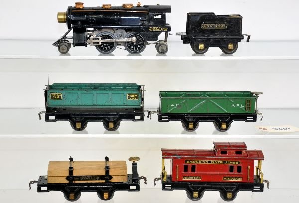 6Pc American Flyer Steam Freight Set: Circa 1934. Includes a 614 loco, some wheel fatigue; 1329 tender with ornimental back-up light, tabs off coal pile; 3013 sand car; 3009 dump car; 3006 lumber car; 3014 caboose. All show moderate to he
