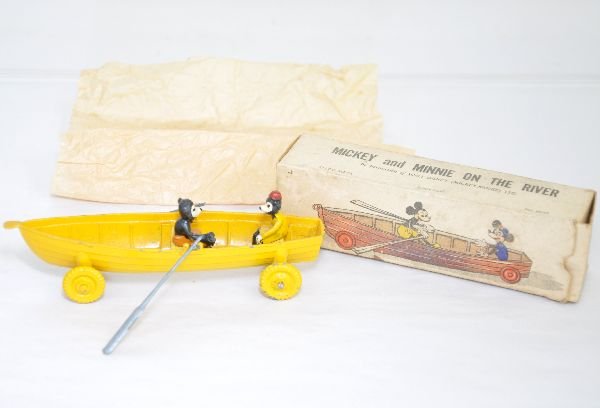 Scarce Salco Mickey & Minnie On The River: 1950s diecast Disney set. Includes a cast canoe with wood benches; Mickey Mouse & Minnie figures with oars. It shows very light wear with wrapping & box, C7+