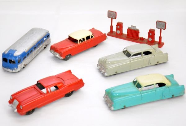 6 Tootsietoy Jumbos: Includes Future Car coupe; 2 Cadillac sedans; Greyhound bus; Cadillac coupe with litho tin bottom & Gas Pumps. All show light playwear and should clean to C7-7+