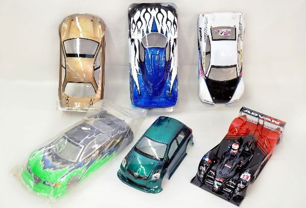 1/10 Scale Import RC Car Shells Painted: 6 painted RC car shells, all imports. 1 DNA racecar, 1 Mach GoGo, 1 Honda Formula 1, 1 Toyota Yaris, and 2 generic race cars. All shells have little to no handling wear. Examine photos or call for mor