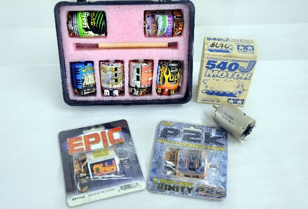Assorted RC Car Electric Motors: 6 Trinity motors in original padded carrying case. 5 out of 6 motors and case show light playwear. 1 Tamiya 540 J motor in original packaging, shows light play wear. 1 EPIC Binary2 Pro Stock in origin