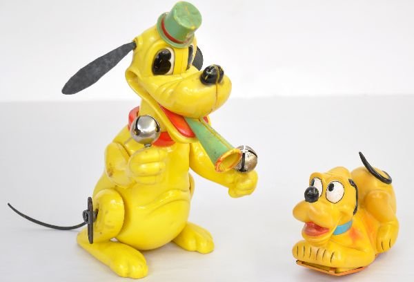 2 Early Disney Pluto Toys: Both plastic, Pluto Cheerleader is Marx, mechanism functions with moving arms with bells & rocks back & forth; Cragstan friction Pluto. Both could use a cleaning, but show light to moderate playwear, 