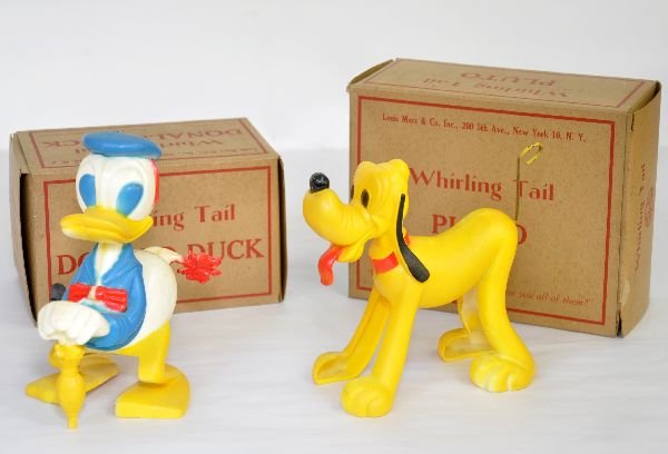 2 Boxed Marx Disney Toys: Includes hard plastic Whirling Tail Pluto & Donald Duck. Both mechanisms function. Toys show light playwear with nice original boxes. They should clean to C7+-8