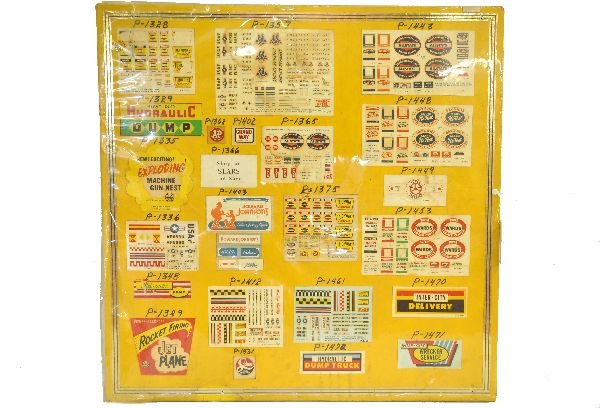 Rare Marx Factory Decal Board: 28" square, yellow painted wood board with original Marx decal sets displayed with the toys production # for guidance. It is fairly clean and a very unique piece of Marx Factory Production history