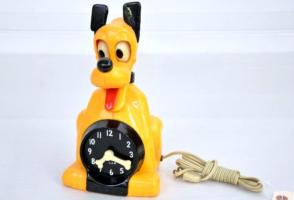Disney Pluto Animated Clock: Nice 1950s hard plastic clock by Allied. It is 9" tall and can mount on wall or sit on mantel. The tongue & eyes move and it is functional. It shows light wear and is clean, C7+