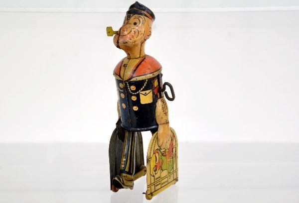 Marx Popeye Walker with Parrot Cage: Litho tin, 8 1/2" tall. Mechanism functions with walking motion, has original pipe and shows moderate playwear, C6