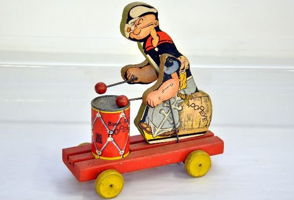 Fisher Price 491 Boom-Boom Popeye: Tough toy to find nice. Paper Litho on wood, 10" tall, yellow wheel version. Popeye drums when rolled, missing string, but litho is fairly clean & bright, showing light playwear, C7+