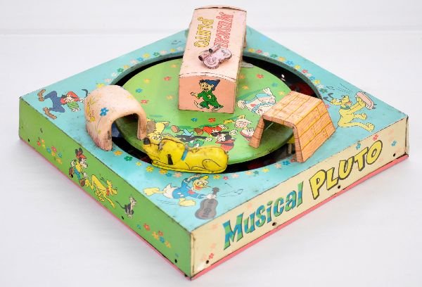 Unusual Marx Musical Pluto: Scarce Honeymoon Express style toy with a tin Pluto. When spinning around it has a mechanical Zylotone inside playing a tune. It shows light to moderate playwear, functional, C7