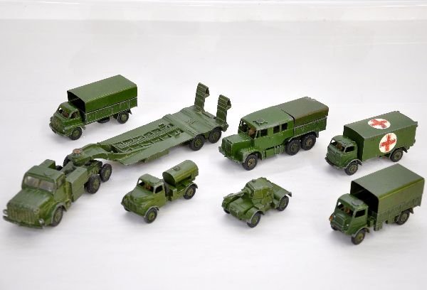 7 Dinky Military Vehicles: Includes 660 Mighty Antar Carrier; 670 Armored Car; 643 Water truck; 521 3 ton truck; 623 Army Truck, 1 wheel cracked; 689 Medium artillery tractor; 626 Ambulance. All show moderate playwear, C6-7