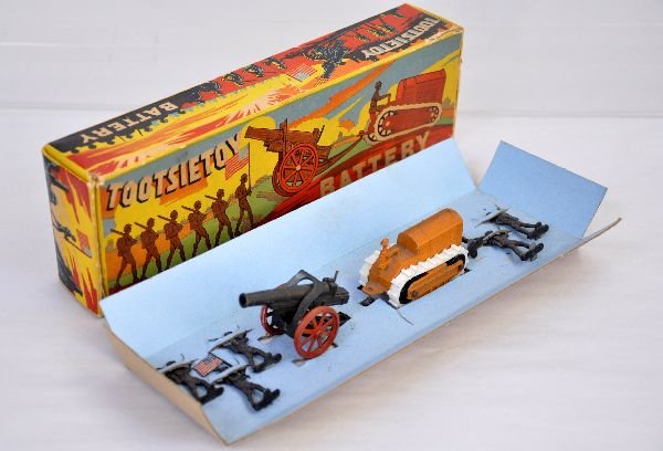 Unusual Boxed Tootsietoy 197 Military Battery: Includes a dozer with supple treads; cannon and 6 unusual 2 dimensional army figures with a flag bearer. They appear near like new showing light wear with box & insert, C8