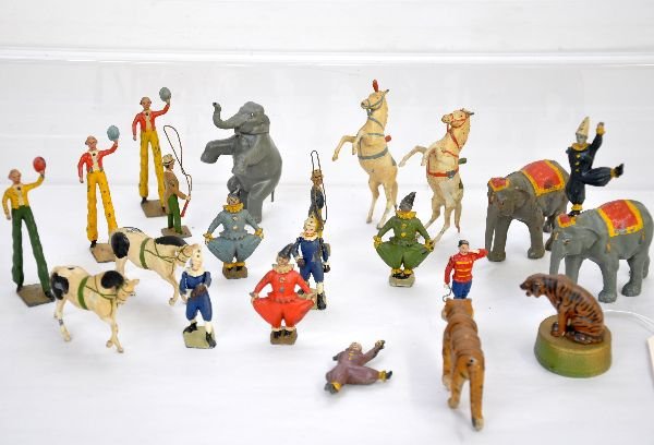 23 Britains Circus Figures: Nice assortment including Lion tamer with lion & perch; Horse tamer with 2 standing horses; elephant tamer with standing elephant; 2 elephants with clown riders, missing arms, holes a bit worn so figu