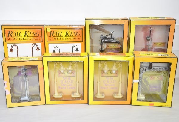 8 MTH RailKing Accessories: Includes 30-11007 water column; 30-11005 block signal; 30-1009 signal bridge; 2 #1056 street lamps; 1030 & 1031 street lamps; 30-11-025 1 over signal. All appear like new in boxes, C8+-9
