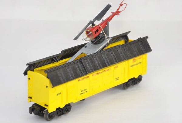 Lionel 3619 Helicopter Reconnaissance Car: Clean light yellow version with nice original copter. Mechanism is functional. It shows light playwear, C8