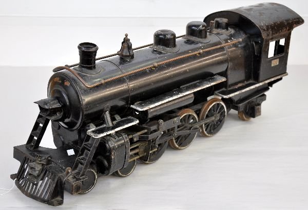 Buddy L Steam Locomotive: Painted pressed steel ride on loco, circa 1938. 26" long with broken front coupler. It shows moderate to heavy playwear, C5