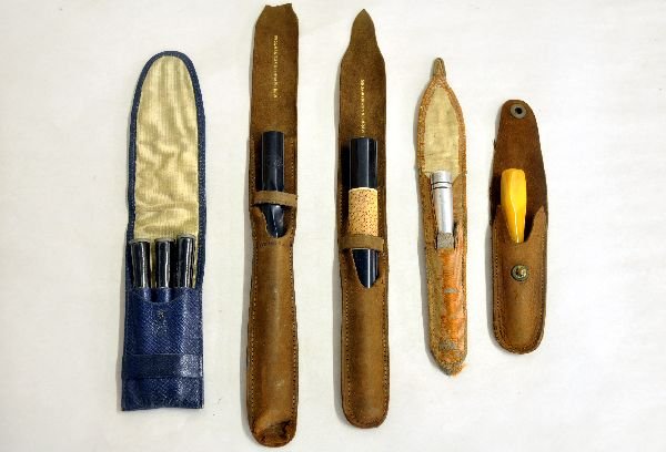 5 Assorted Deco Cigarette Holders: Includes a 5" Dunhill twist carved Bakelite holder; 4 3/4" Ebony holder with ivory rings and Meerschaum chip inlay; 3 1/4" ebony & metal holder; 3pk glazed paper holder set; 2 1/2" amber holder, all w