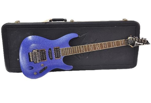 Ibanez S470DX Electric Guitar: S/N CP04088847. Guitar is in a purple metallic finish, with mother of pearl fret inlays. Missing rear nut bolt. Shows moderate play wear on the frets and finish is faded off on upper horn and small sp