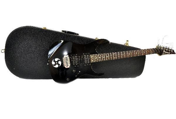 Ibanez RG120 Electric Guitar: S/N 030119072. Guitar is gloss black with a white fret board. Shows moderate play wear, and small areas of sticker adhesive. Missing pickup selector knob, however it appears to be functional along wit