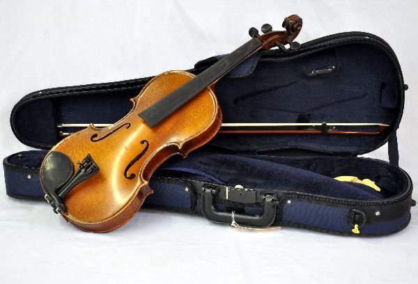 Karl Wilhelm Model 22 Violin: Violin size 4/4, S/N 72505. Violin is in a hand-applied oil varnish. Shows little to no play wear. Sticker residue on neck. All components appear functional. Violin is not strung. Comes with bow, resi