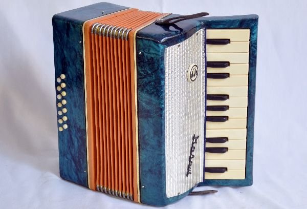 Super Russian Accordion: #14 bass accordion, S/N D22030. Very rare in a blue marbled enameled finish. Shows very light play wear. Light scuffs on marbled finish. Paper element is all intact and unripped. All other components 