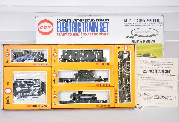 Boxed Cox HO Military Set: Includes a US Army F7 A diesel; flat with grader; flat with tank & caboose, track & transformer. All appear new in boxes with worn set box, C9