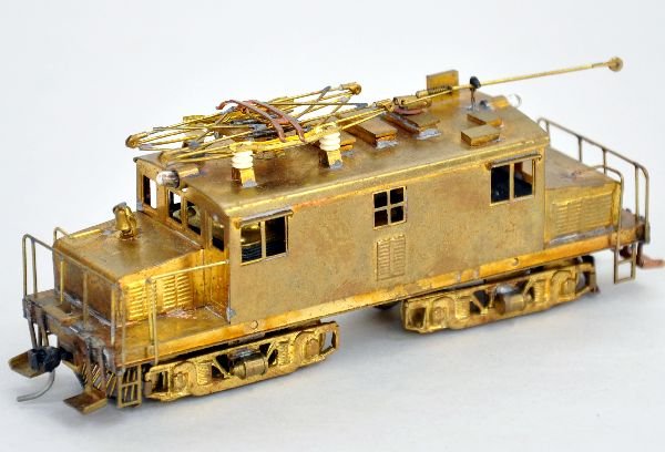Brass HO Center Cab Electric: Unpainted Brass with vertical open frame motor. It is tarnished, but shows light playwear with pantograph & trolley pole, C7+