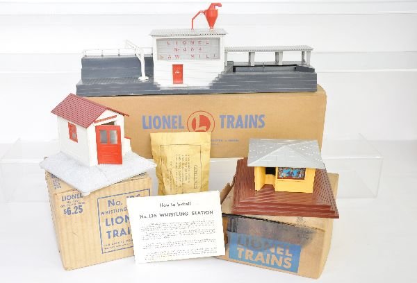 Boxed Lionel 464, 125 & 114 Accessories: Includes a 464 lumber mill, complete with packet & inserts, but red exhaust stack has a repaired crack at base; 125 whistling shack with instructions; 114 newsstand with whistle, box is rough. All sho