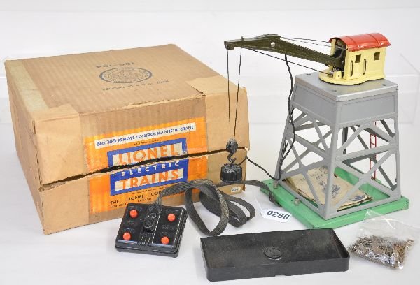 Boxed Lionel 165 Magnetic Crane: 1942 production with 92 gray super structure & silver painted top. It is complete with controller, instructions, original loose scrap pieces(some rusty) & a chipped 160 bin. It has its original box wi