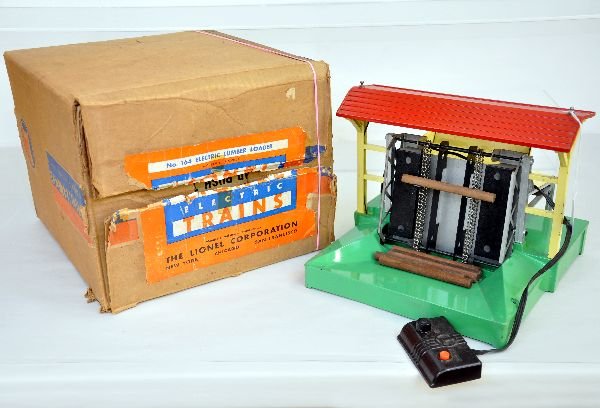 Boxed Lionel 164 Lumber Loader: Clean & shiny with controller & 6 assorted logs. It shows light playwear with rust spots on controller base. The box shows light to moderate wear with both scarce inserts(due to shrinkage, box wont ho