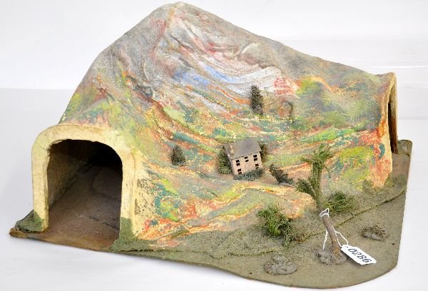 Lionel 123 Landscaped Tunnel: O gauge 90 degree felt tunnel. Cardboard base version with Lionel label underneath. It is missing the two front shrubs, but a bit dirty with light shrinkage; can fit train through. It shows moderate w