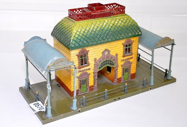 Nice Bing Café Station: Circa 1920s hand painted tin with island glass inserts, missing 1. It has a small dent in one side awning and is missing its telegraph post on top. Otherwise shows light wear, C7