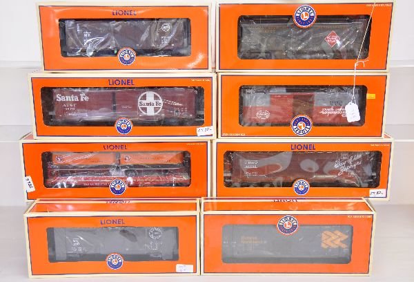 8 Lionel Freight Cars: Includes 27237 boxcar; 27246 boxcar; 17596 Piggy back flat; 27221 & 27218 end door boxcars; 17364 milk car; 17275 boxcar. Most show light runtime with boxes, C8+-9