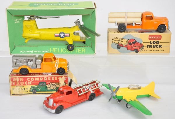 5 Nice Hubley Vehicles, 3 Boxed: All painted die cast bodies. Boxed 1484 Helicopter, C9; Boxed 459 Log Truck, C9; 466 Air Compressor Truck, ob worn, C8; Fire ladder truck, C6+ & fighter plane, C7+