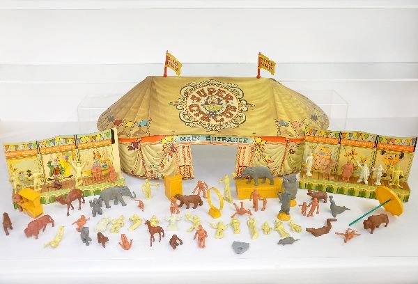 Partial Marx Super Circus Playset: Includes the tin tent with both flags; both side show stages, 5 white figures, 15 yellow figures, 15 brown figures, 8 gray animals, 11 brown animals, plus 9 plastic accessory pieces, hot dog cart is c