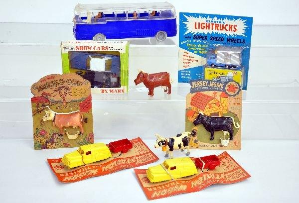 Assorted Marx Toys lot: Includes a Show car battery toy (like Motorific), 1964 Plymouth fury in box; 2 Auto-wind hard plastic vans on cards; 4 milking cows, 2 on worn cards with pails; Light trucks box truck, mint on card; 1