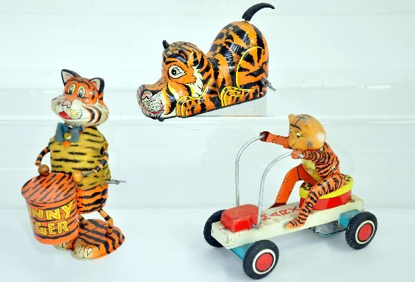 3 Tin Marx Tiger Toys: Includes a 7" Funny Tiger drummer; 6" stalking tiger wind-up with mystery action; 6 1/2" Tiger on cart friction toy. Mechanisms function and all should clean up to C7 or better