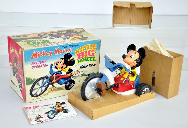 Boxed Marx Mickey Mouse Big Wheel: Cute battery operated toy, plastic, 9" long, mechanism is functional at time of test. It is dirty from display but shows light wear. It has a nice original box with inserts & instructions, should clea