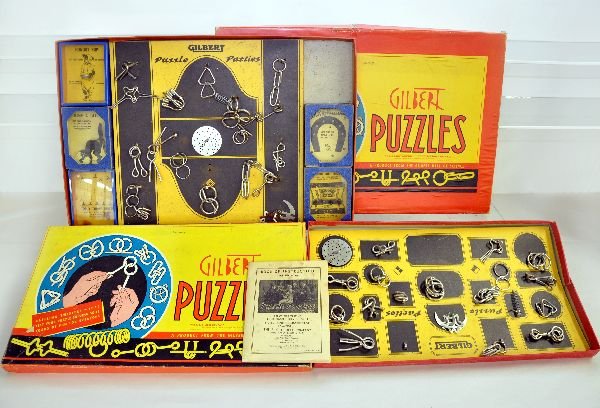 2 Large AC Gilbert Puzzle Sets: Includes a 1032 & 1033 set. The 1032 appears complete with instructions; The 1033 set appears to be missing 1 palm puzzle & instruction book. They show light playwear, but need to cleaned up from year